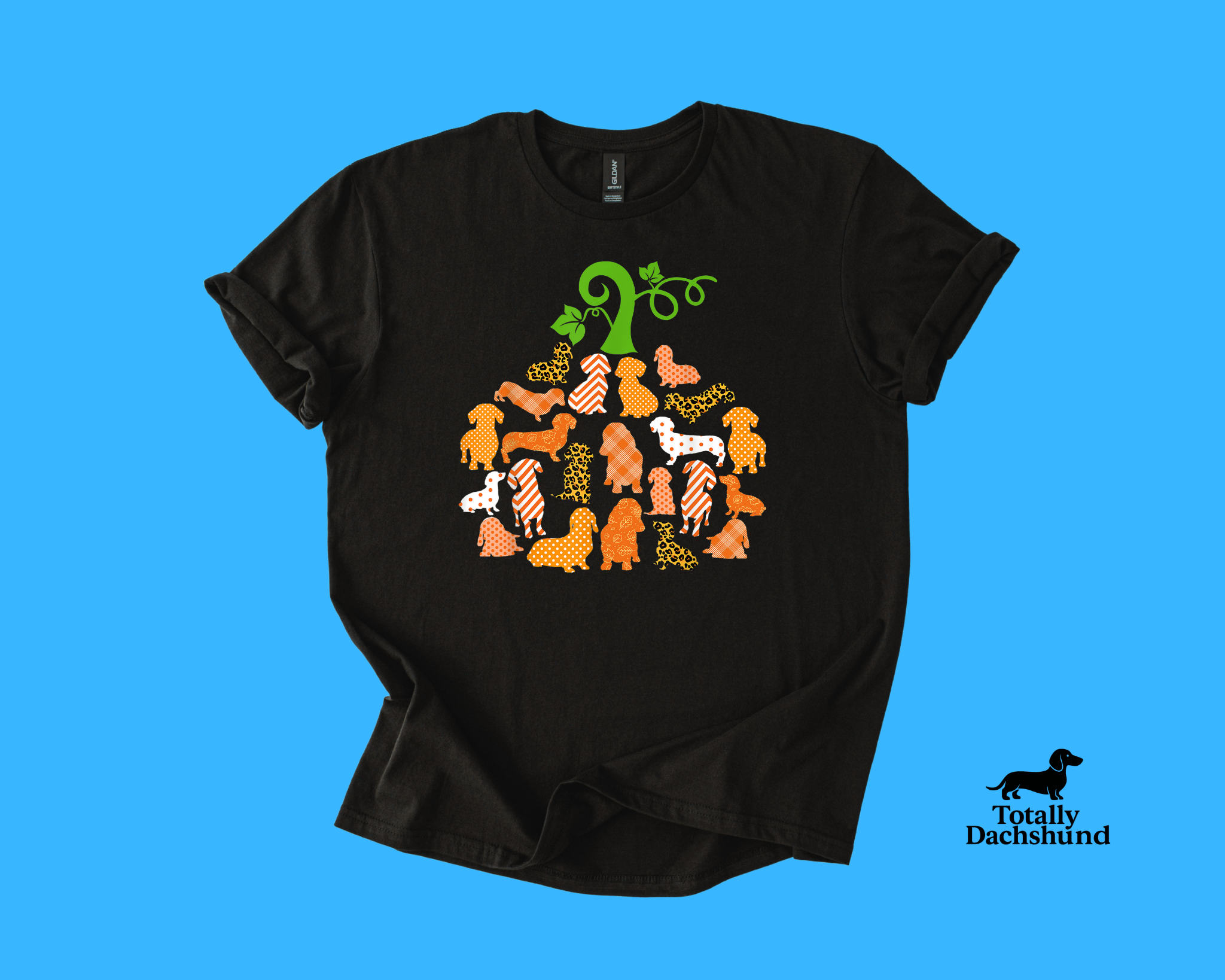 Black shirt with pumpkin-shaped design made of orange patterned dachshund silhouettes – perfect fall and Halloween tee for dog lover