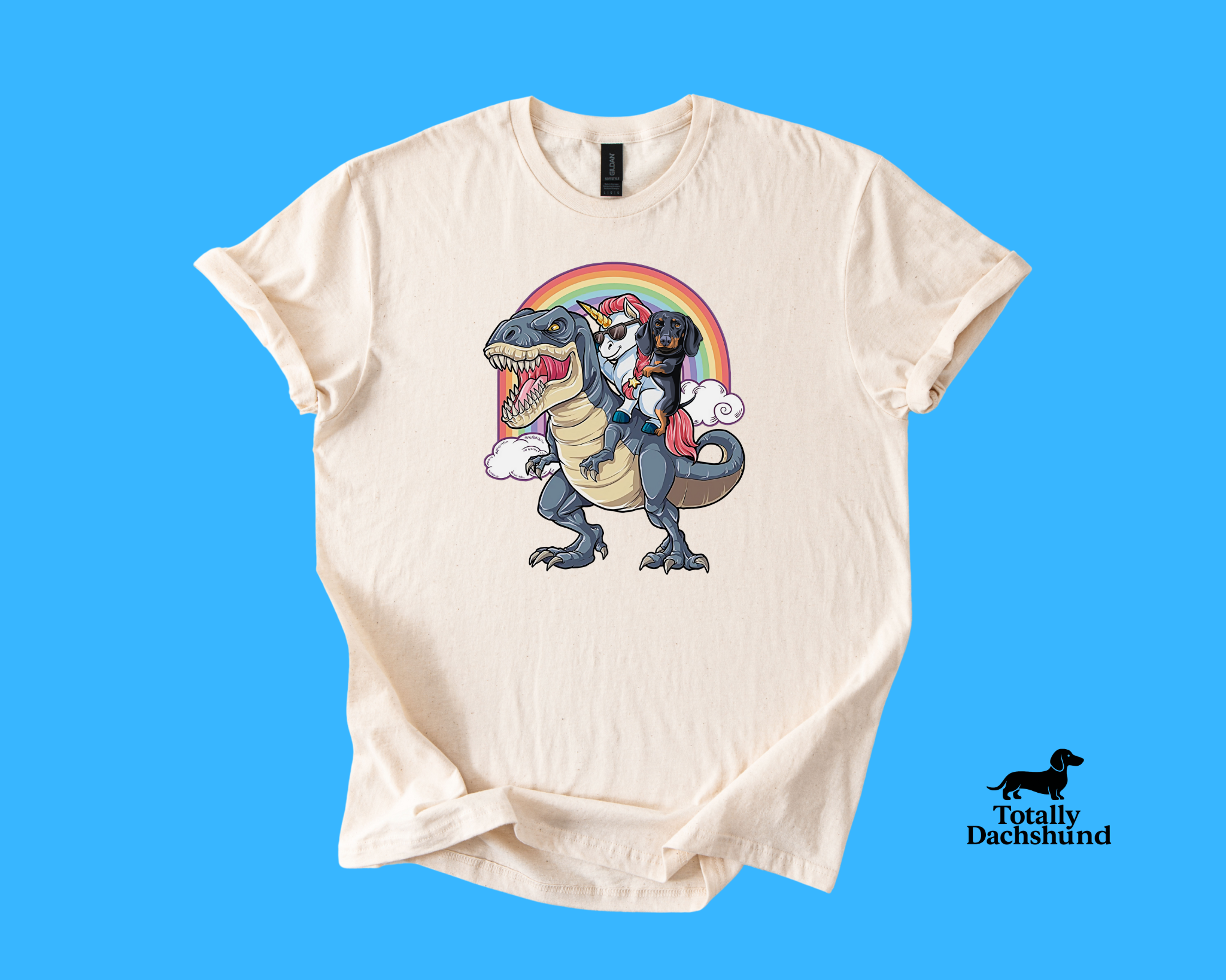 Funny dachshund riding a unicorn with sunglasses on a T-Rex under a rainbow – white novelty dog shirt